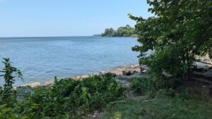 Lake Ontario shoreline with strip of Hamlin Beach and green foliage